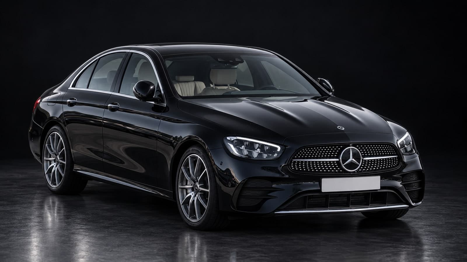 Black Mercedes E-Class Saloon, front three-quarter view