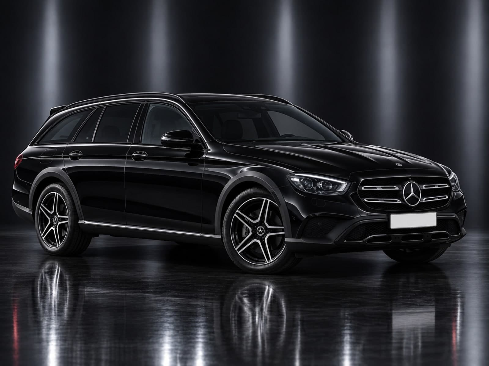 Black Mercedes E-Class Estate in a dark studio, front three-quarter view